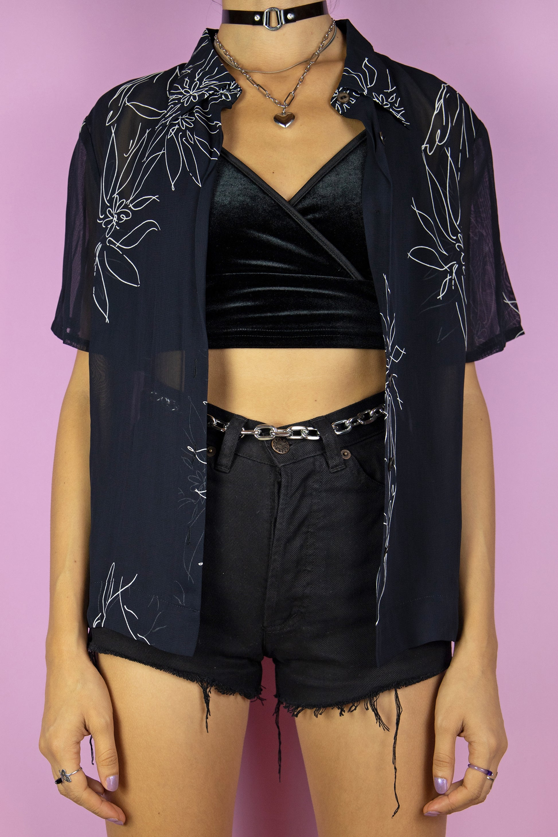 The Vintage 90s Boho Black Sheer Blouse is a short sleeve semi-sheer black top with a collar, buttons and white floral pattern. Summer 1990s shirt.
