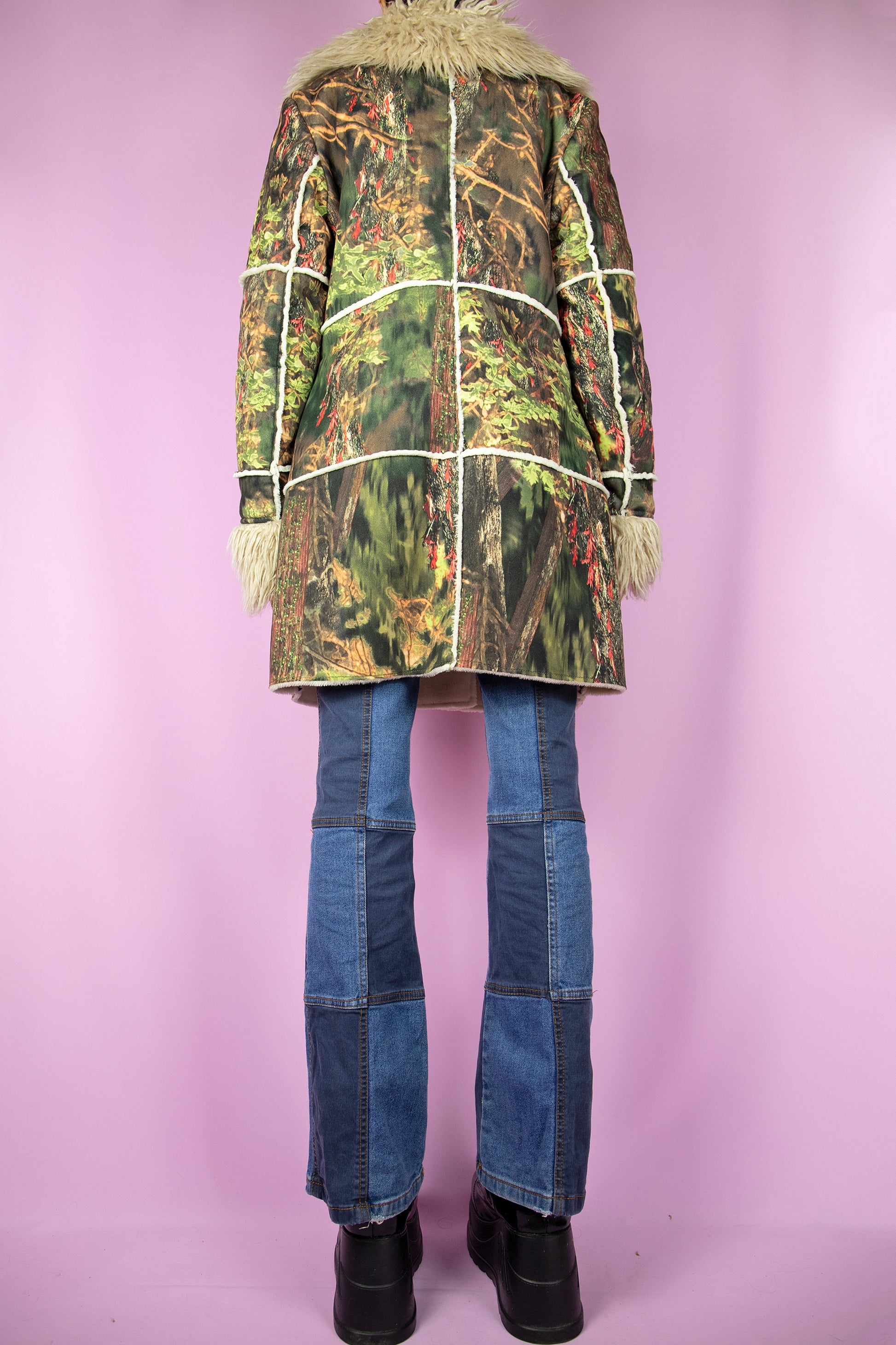 The Y2K Green Penny Lane Coat is a vintage abstract forest graphic printed jacket with beige faux fur collar and cuffs, pockets and toggle closure. Cyber boho 2000s afghan style winter statement coat.
