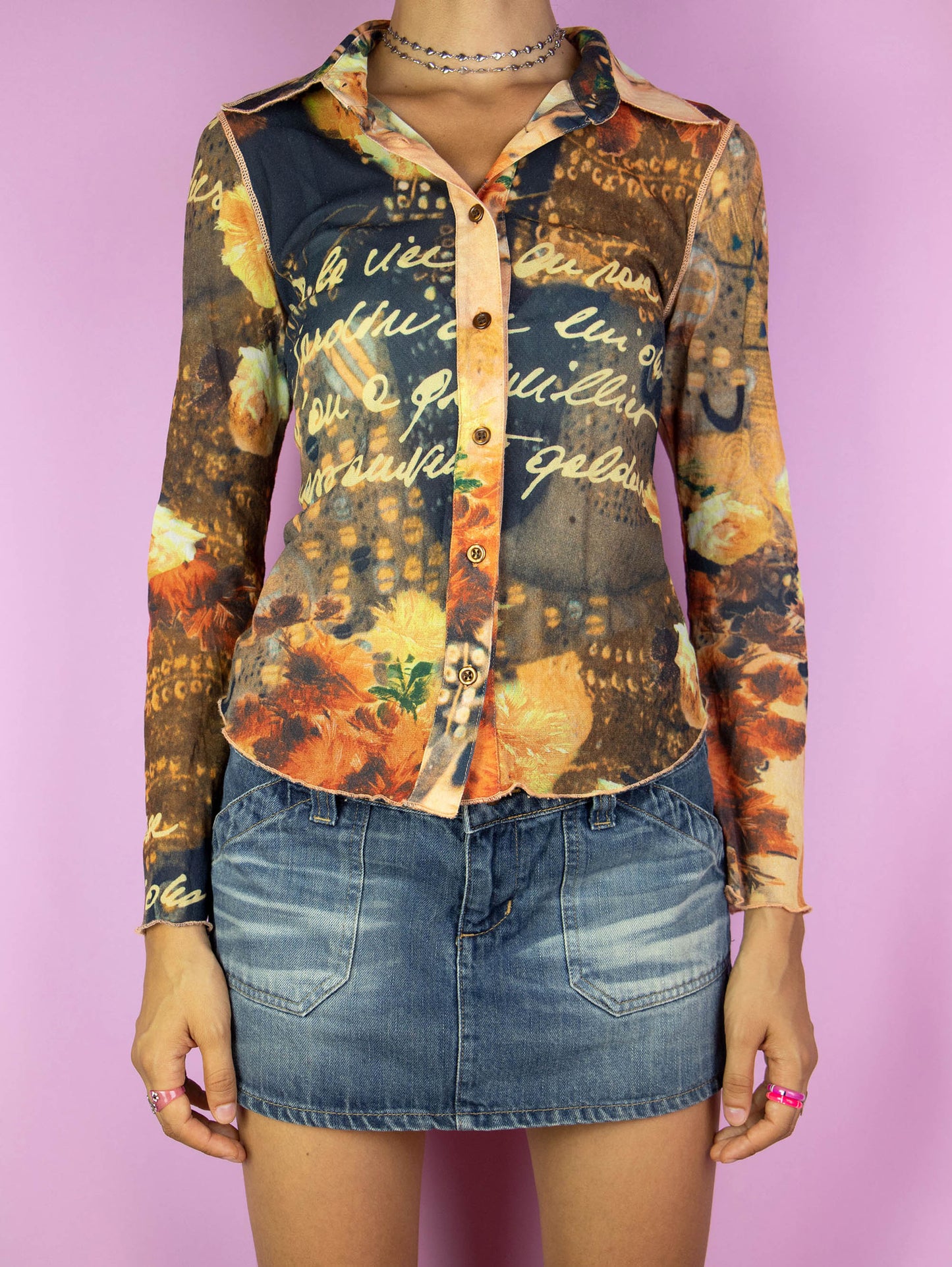 The Y2K Painting Printed Mesh Shirt is a vintage 2000s renaissance abstract graphic semi-sheer blouse with a collar and buttons.
