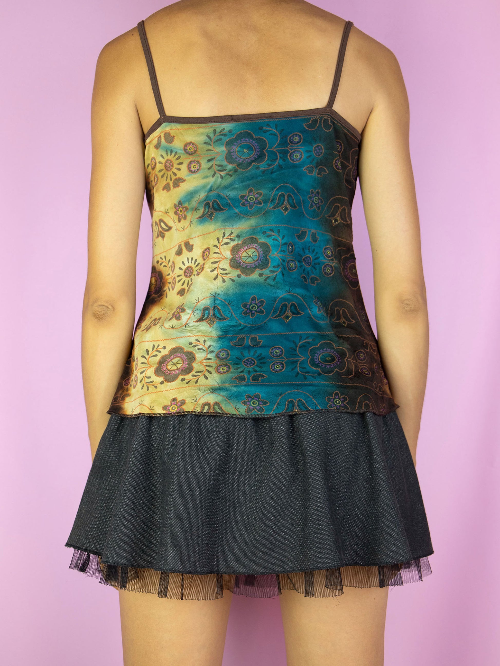 The Y2K Fairy Ruffle Cami Top is a vintage blue and brown multicolored tie-dye floral pattern tank top with a ruffled, ruched front. Boho grunge 2000s summer shirt.
