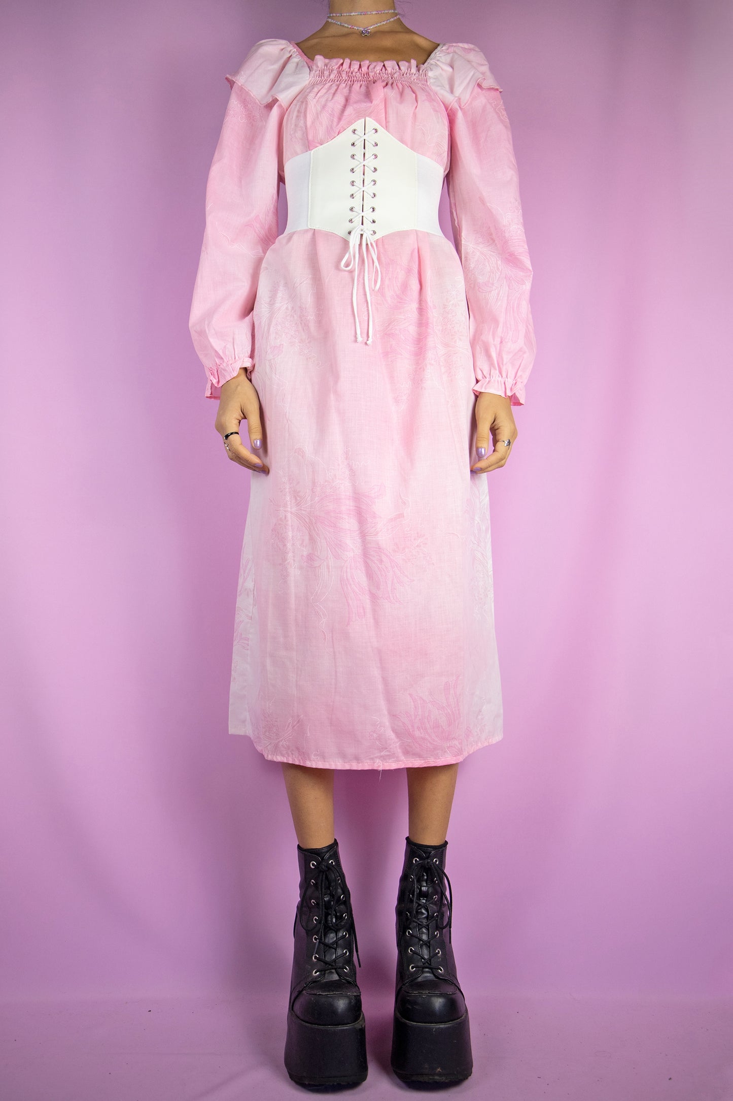 The Vintage 80s Pink Long Sleeve Nightgown Dress is a pastel light pink floral long sleeve midi dress with ruched front. Gorgeous romantic cottage prairie inspired sleepwear 1980s night dress. The white corset shown in the pictures is not included.