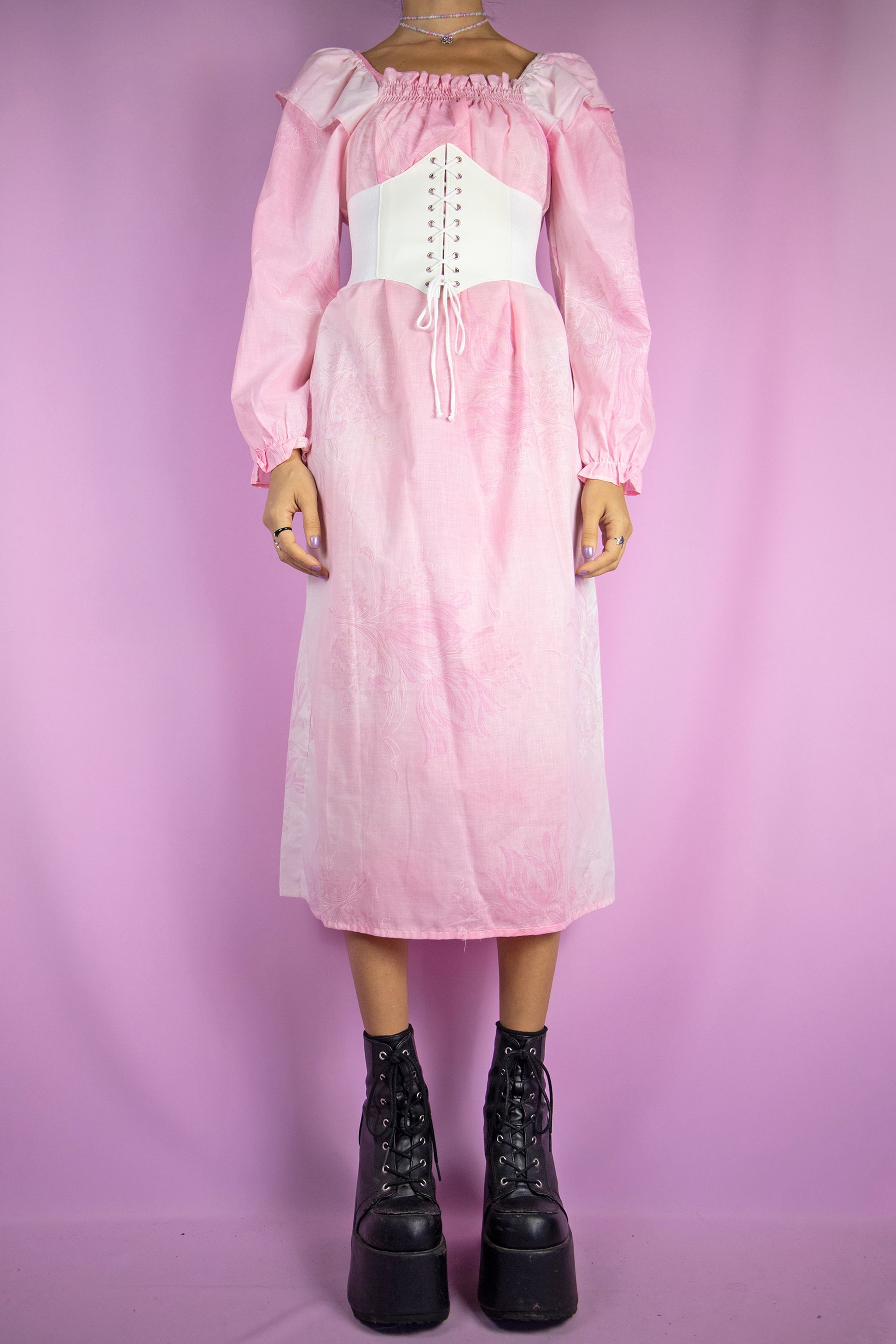 The Vintage 80s Pink Long Sleeve Nightgown Dress is a pastel light pink floral long sleeve midi dress with ruched front. Gorgeous romantic cottage prairie inspired sleepwear 1980s night dress. The white corset shown in the pictures is not included.