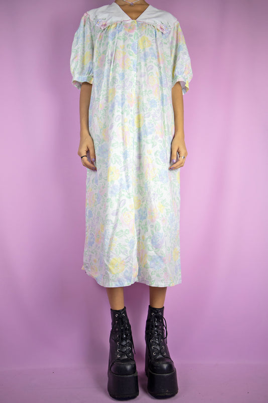 The Vintage 90s Floral Nightgown Dress is a romantic cottagecore-inspired white multicolored printed collared midi night dress lounge sleepwear with short puff sleeves, buttons and pockets.