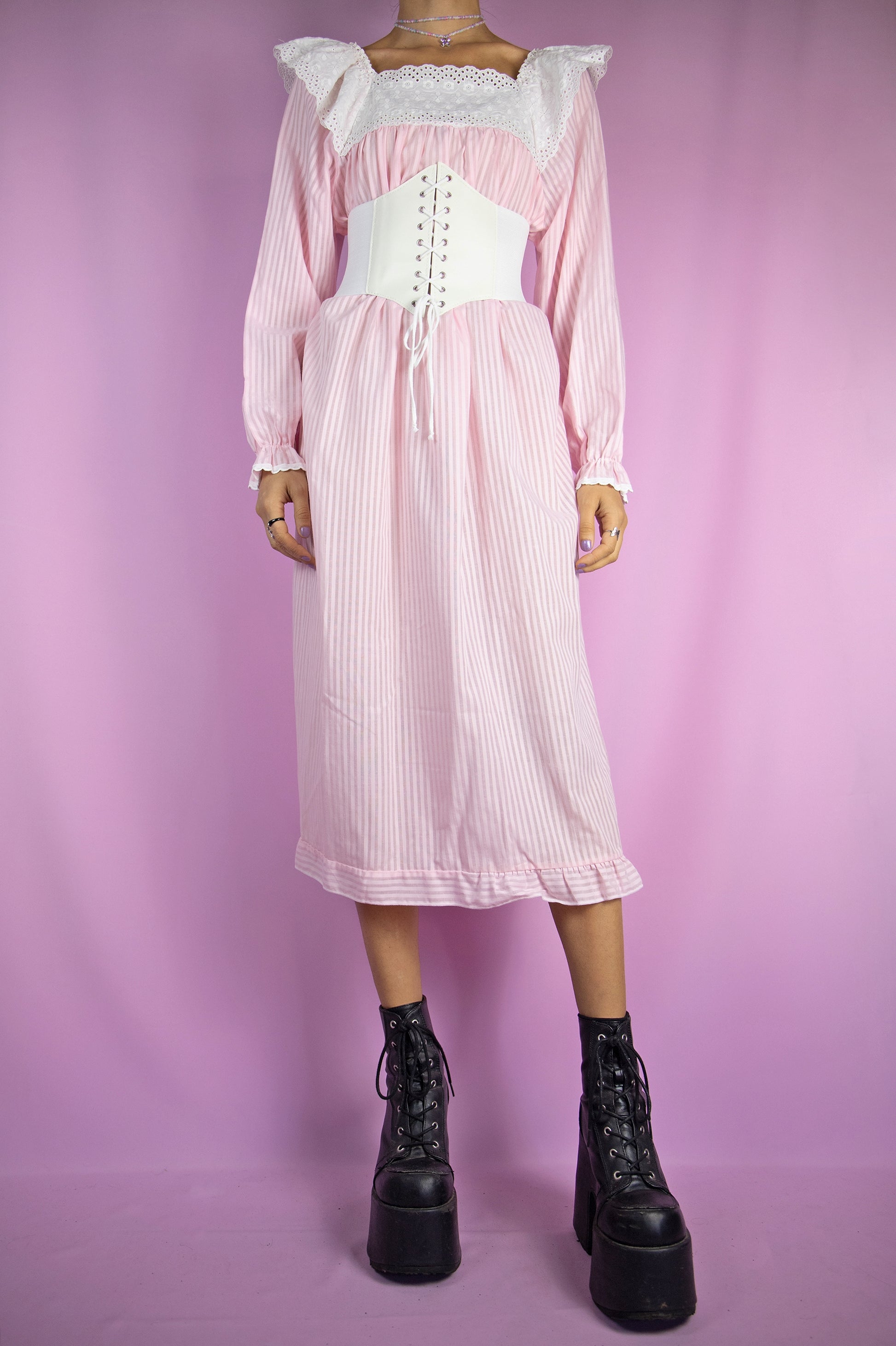 The Vintage 80s Pink Striped Nightgown Dress is a light pastel pink striped midi dress with long sleeves, a white lace collar and a ruffle hem. Gorgeous romantic cottage prairie inspired sleepwear 1980s night dress. The white corset shown in the pictures is not included.