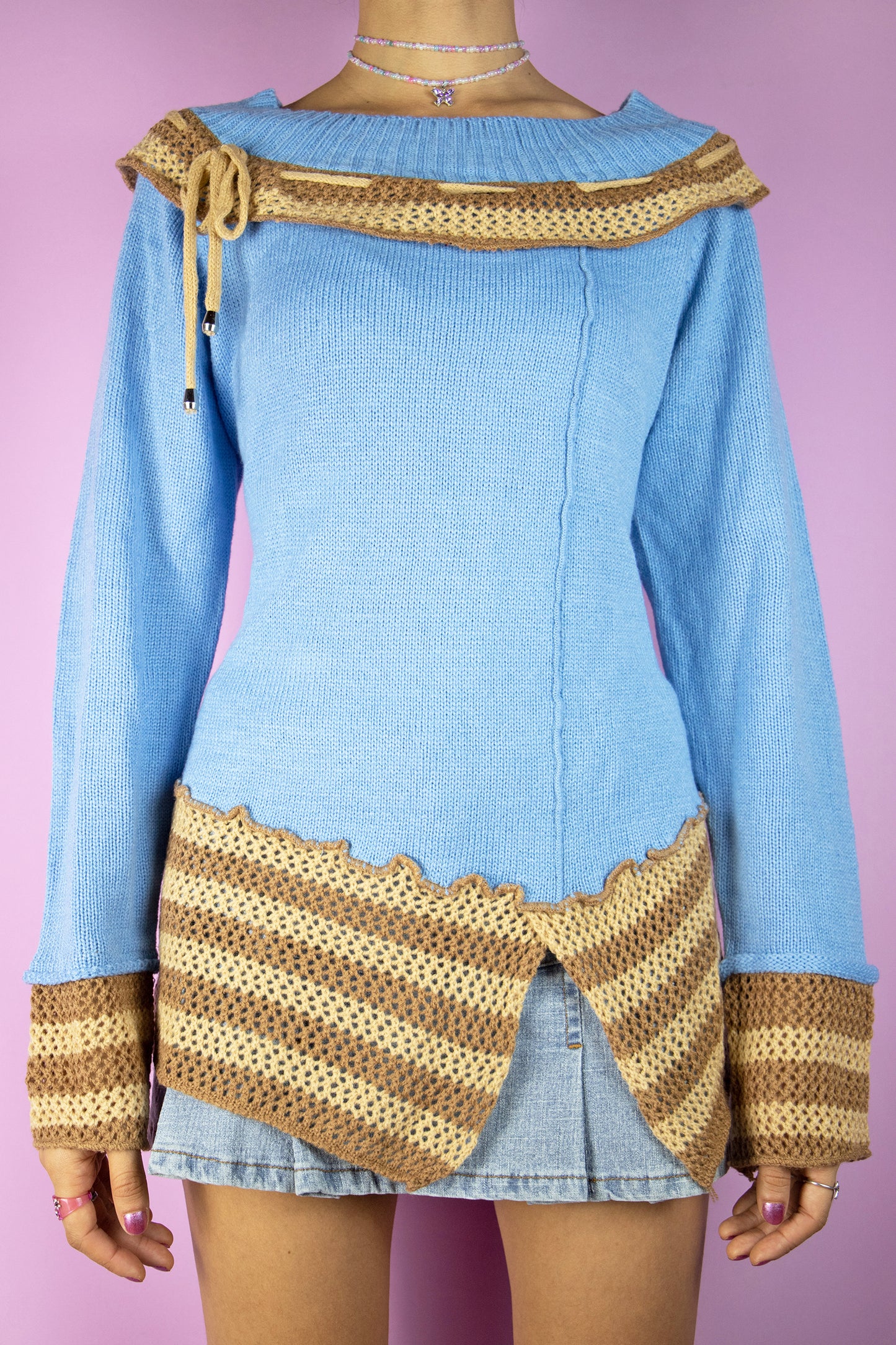 The Y2K Fairy Asymmetric Knit Sweater is a vintage 2000s boho grunge style blue pullover with brown and beige crochet details.