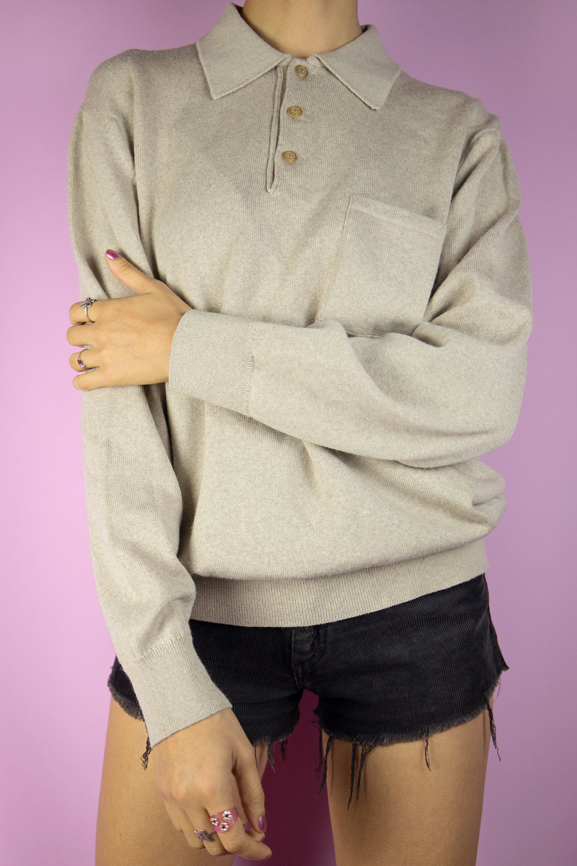 The Vintage 90s Light Brown Collared Sweater is a light brown beige half-button wool blend sweater with a collar and a pocket. Classic retro 1990s preppy knit jumper.
