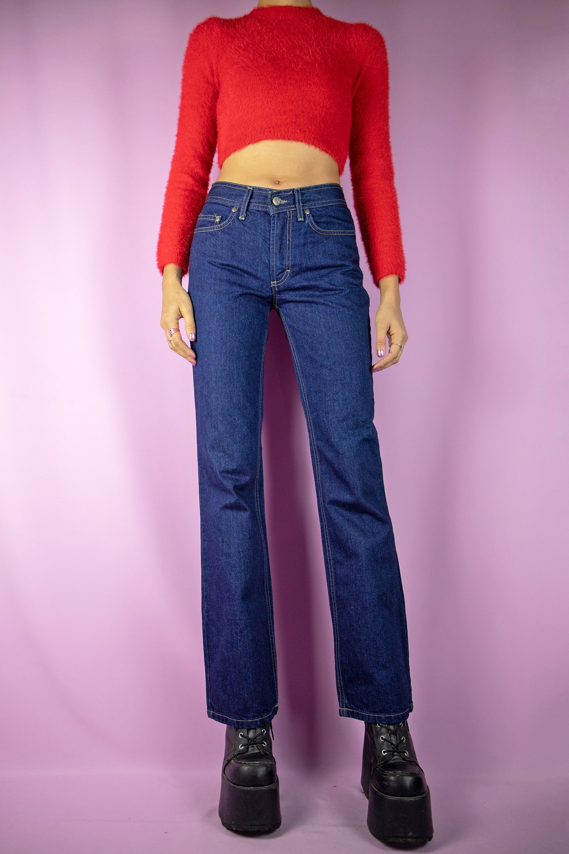 The Vintage 90s Mid Rise Bootcut Jeans are mid-rise straight-leg pants with pockets. Classic retro 1990s casual denim trousers.