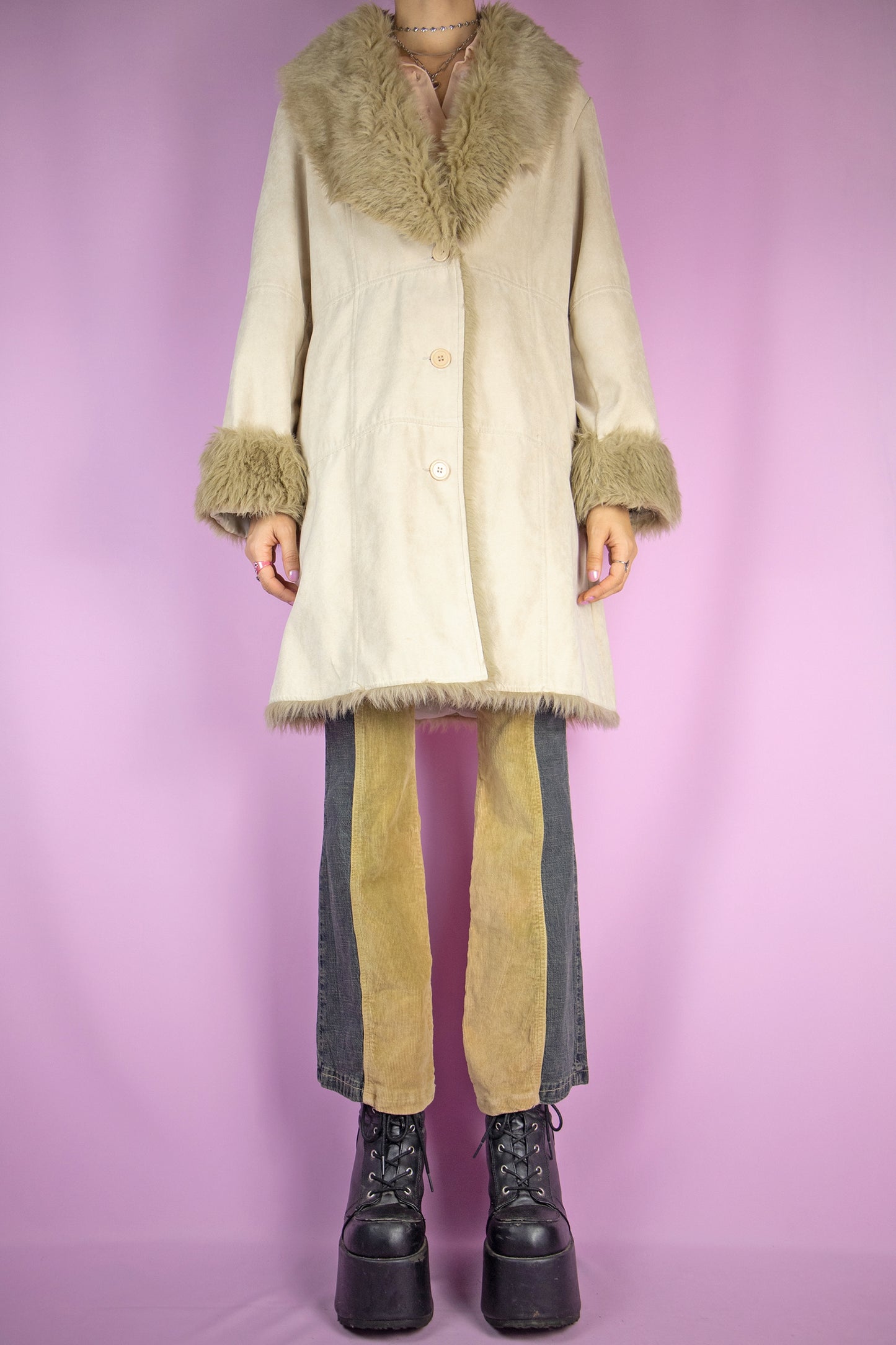 The Y2K Beige Penny Lane Coat is a vintage beige faux suede coat with light brown faux fur collar and cuffs, button closure and pockets. Iconic cyber afghan style 2000s winter statement jacket.