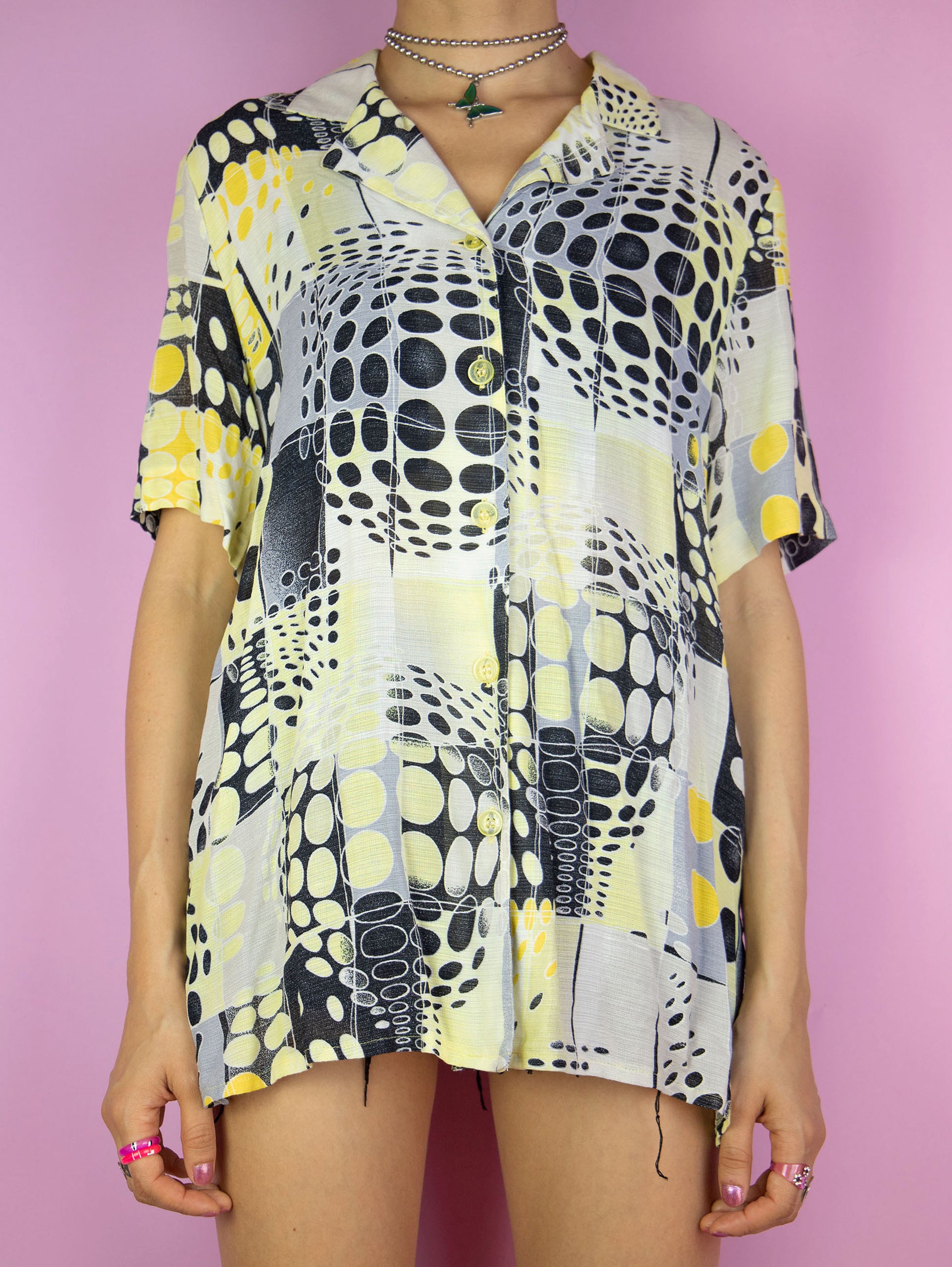 The Vintage 90s Retro Abstract Shirt is a yellow black and white short sleeve crazy geometric pattern collared blouse with button closure. Gorgeous summer festival 1990s top.