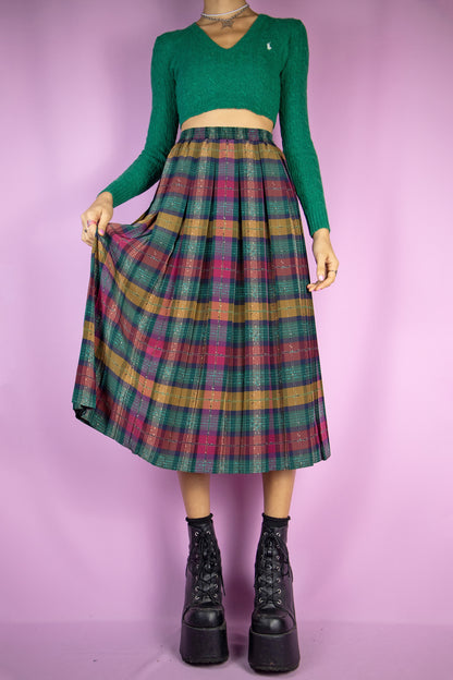 The Vintage 90s Plaid Pleated Midi Skirt is a long green, maroon and mustard check pleated skirt with an elasticated waist. Super cute classic preppy style 1990s skirt.
