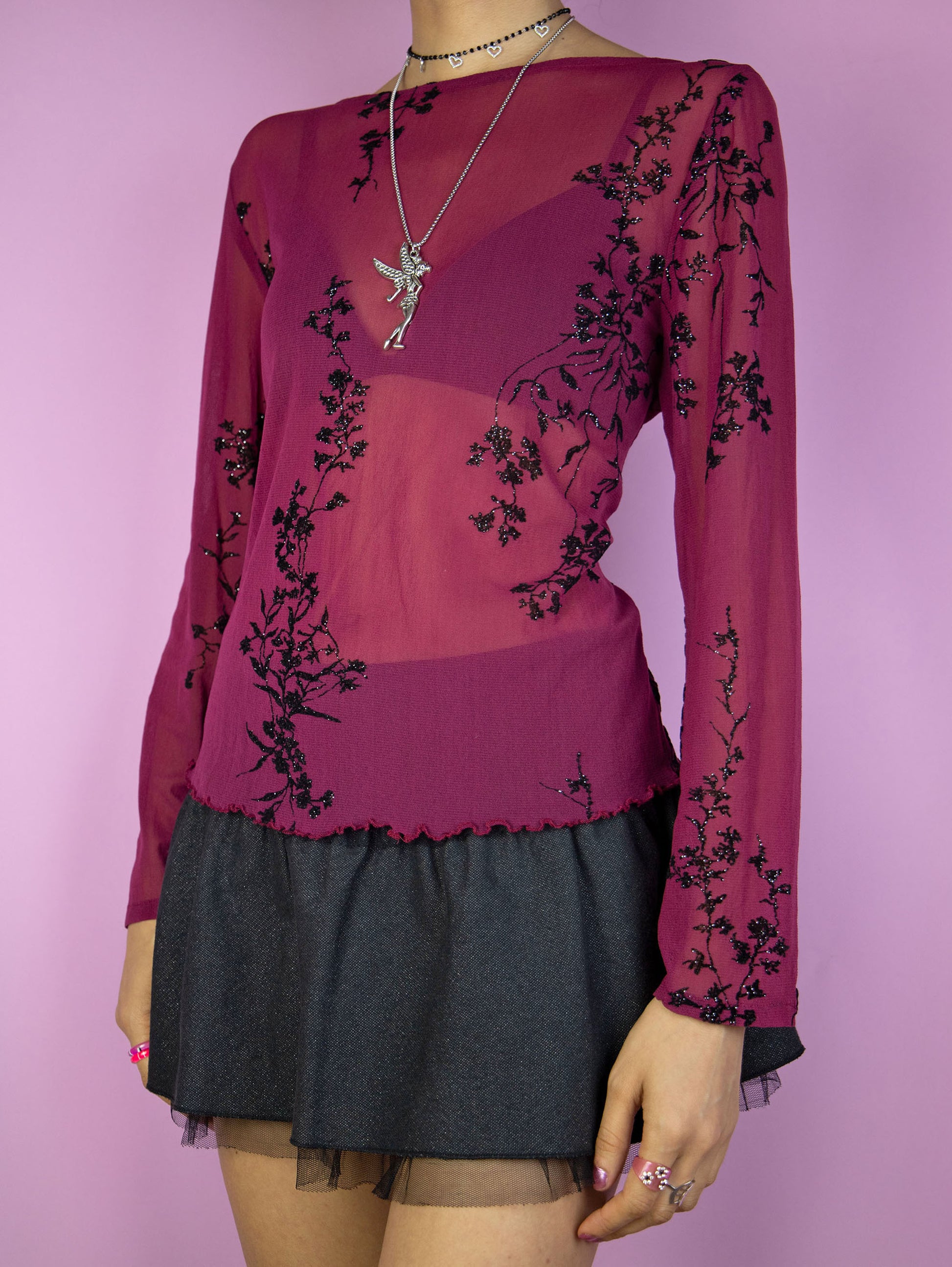 The Vintage 90s Maroon Mesh Top is an elegant dark romantic fairy inspired burgundy red long sleeve semi-sheer top with black sparkle floral details, back button closure and lettuce hem.