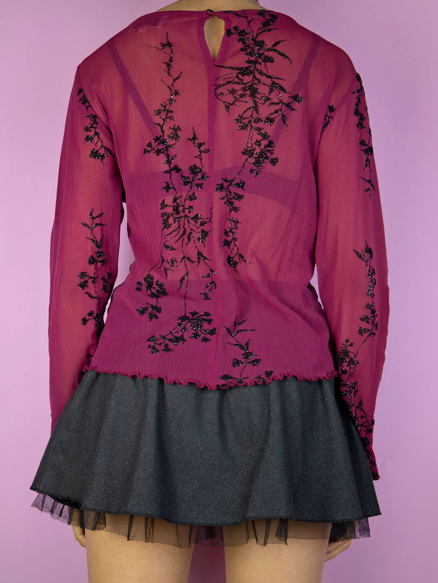 The Vintage 90s Maroon Mesh Top is an elegant dark romantic fairy inspired burgundy red long sleeve semi-sheer top with black sparkle floral details, back button closure and lettuce hem.