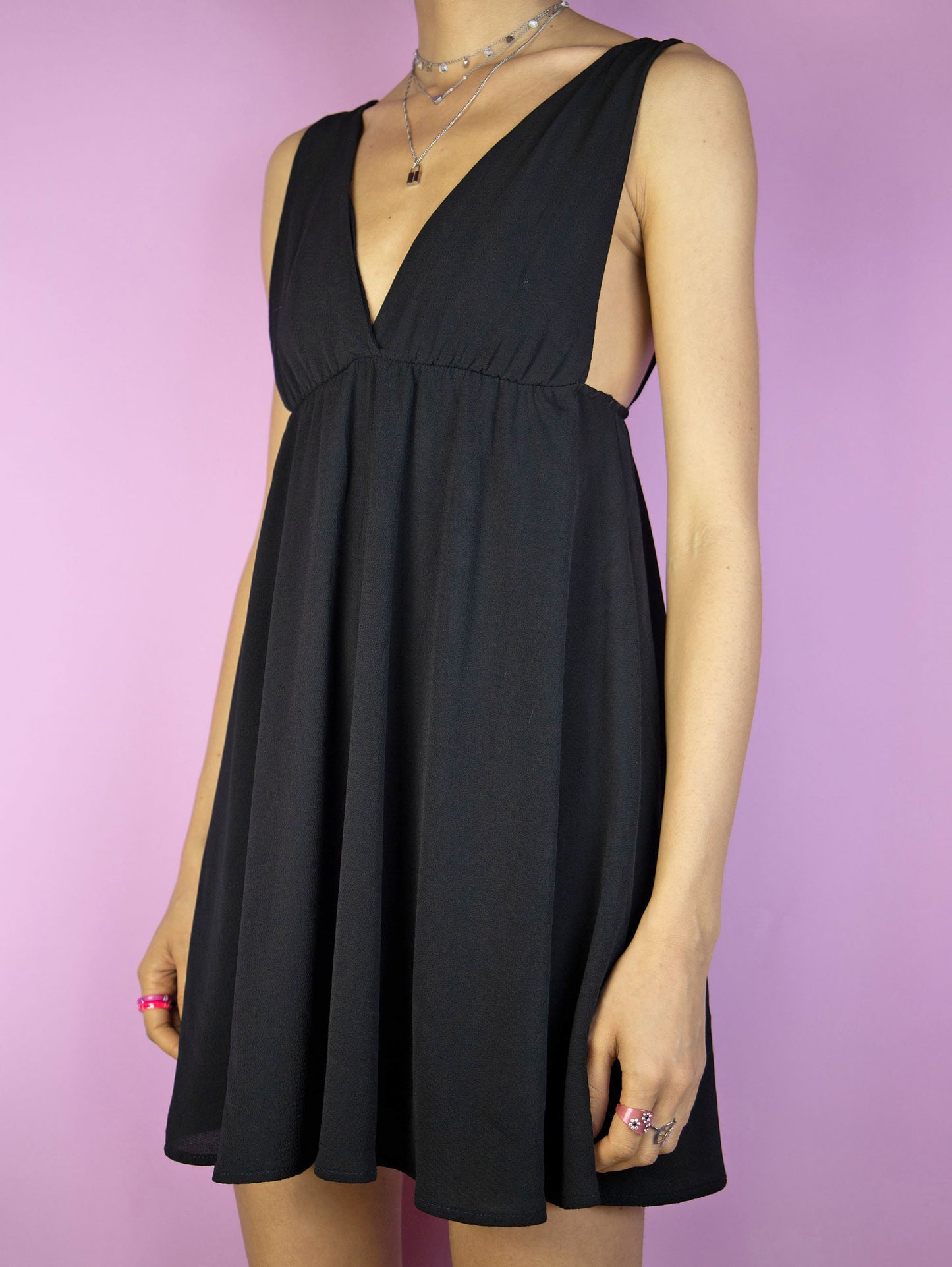 The Y2K Black Party Mini Dress is a vintage 2000s party night out style sleeveless fit and flare dress with a deep v-neck.