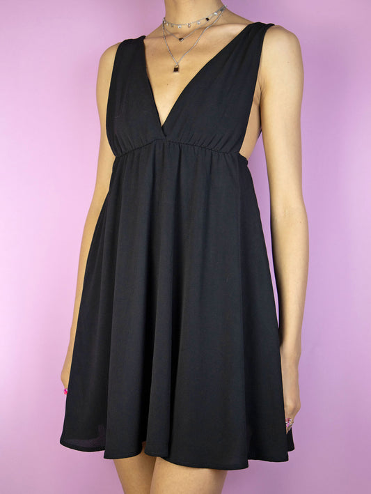 The Y2K Black Party Mini Dress is a vintage 2000s party night out style sleeveless fit and flare dress with a deep v-neck.