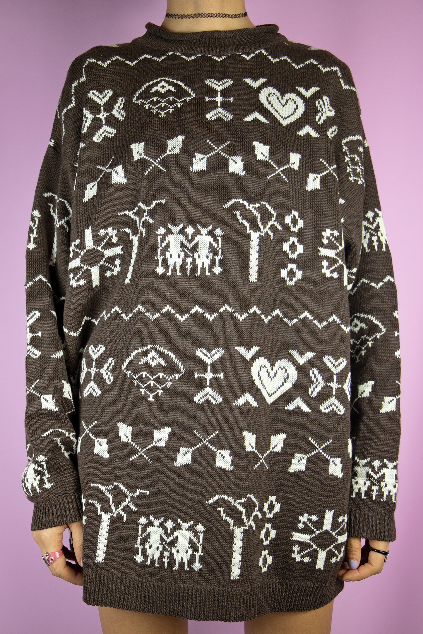 The Vintage 90s Brown Pattern Sweater is a dark brown pullover with an abstract geometric heart pattern. Christmas style 1990s knitted jumper.