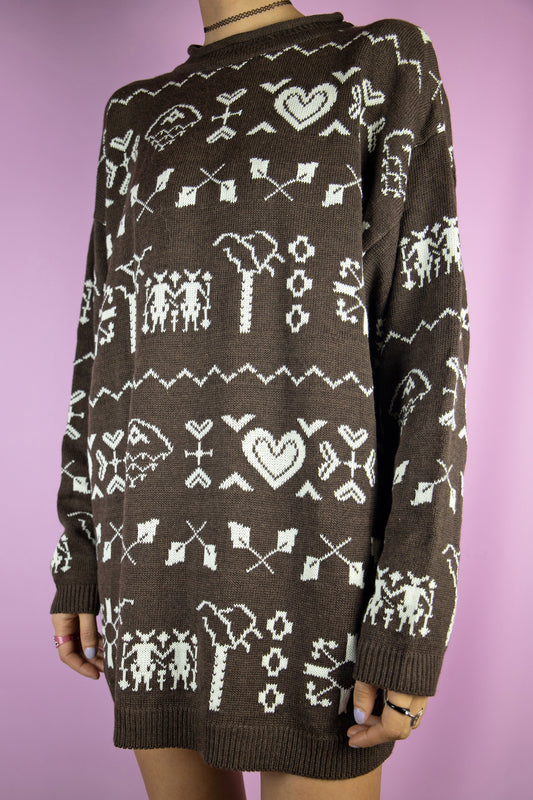 The Vintage 90s Brown Pattern Sweater is a dark brown pullover with an abstract geometric heart pattern. Christmas style 1990s knitted jumper.