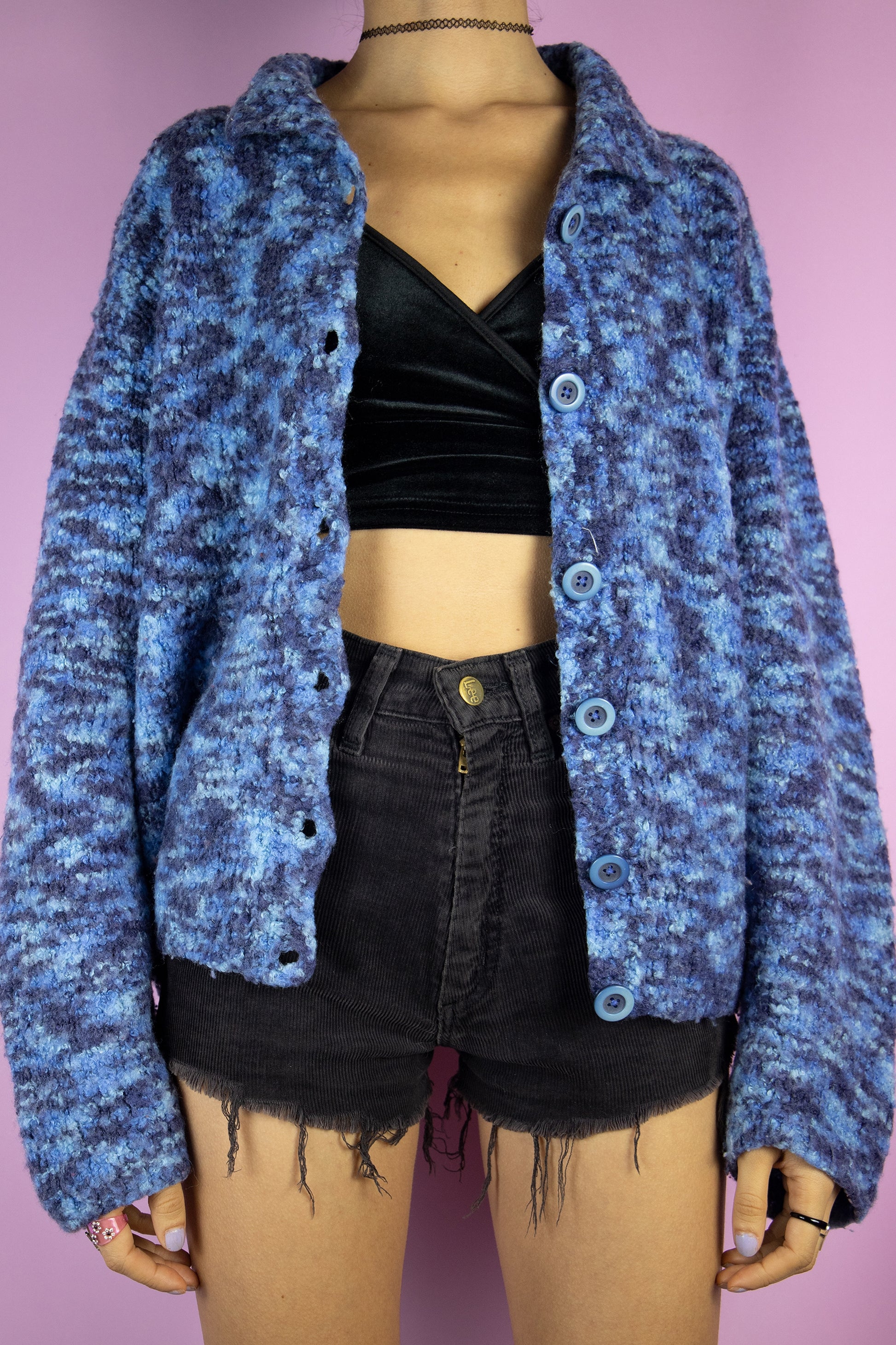 The Vintage 90s Boho Blue Cardigan is a chunky knit blue cardigan with a collar and buttons. Retro grunge 1990s winter sweater.