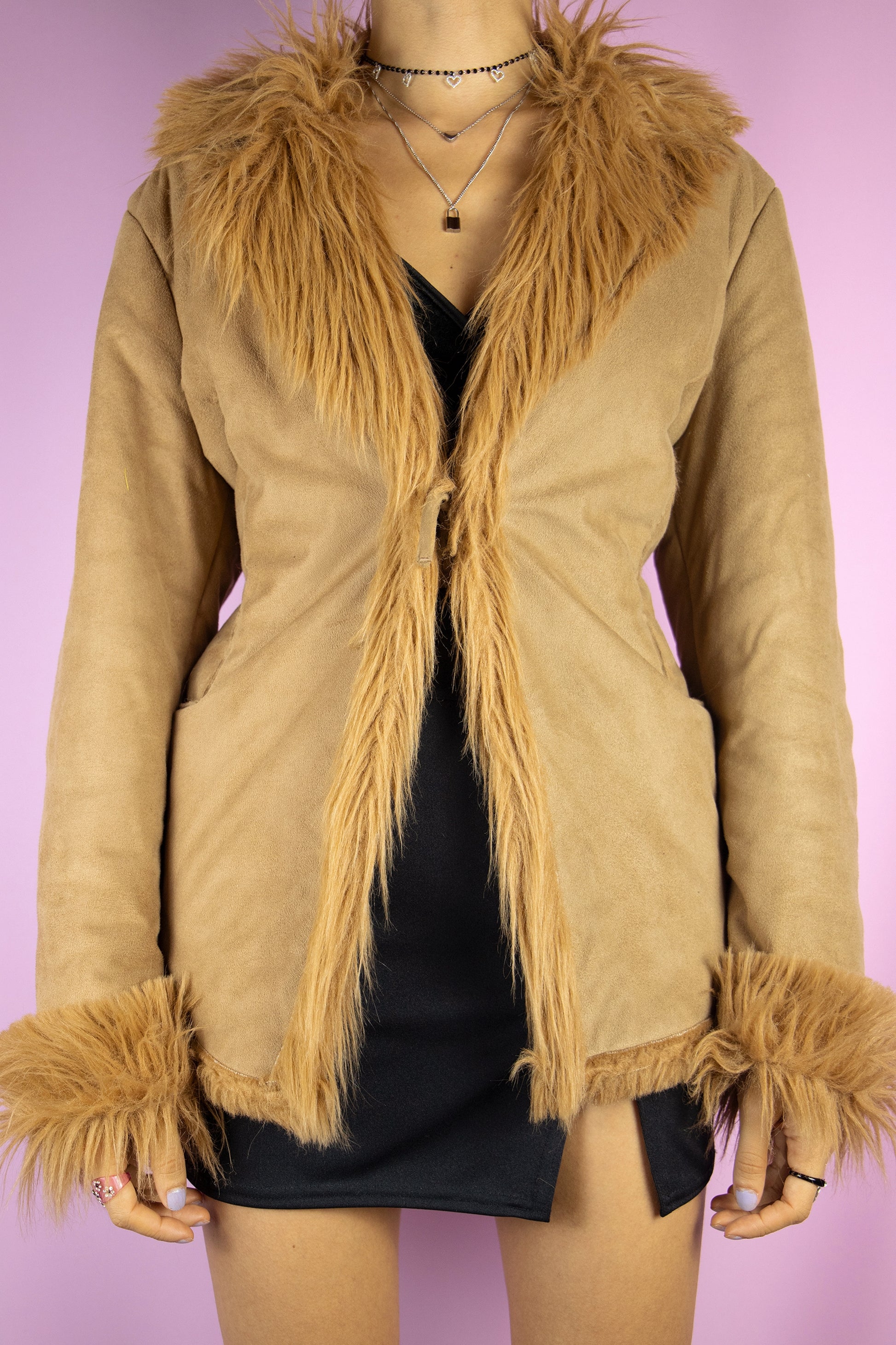 The Y2K Penny Lane Style Jacket is a vintage brown jacket with faux fur lining, collar and cuffs, it also has pockets and ties in the front. Iconic afghan style 2000s winter statement coat.