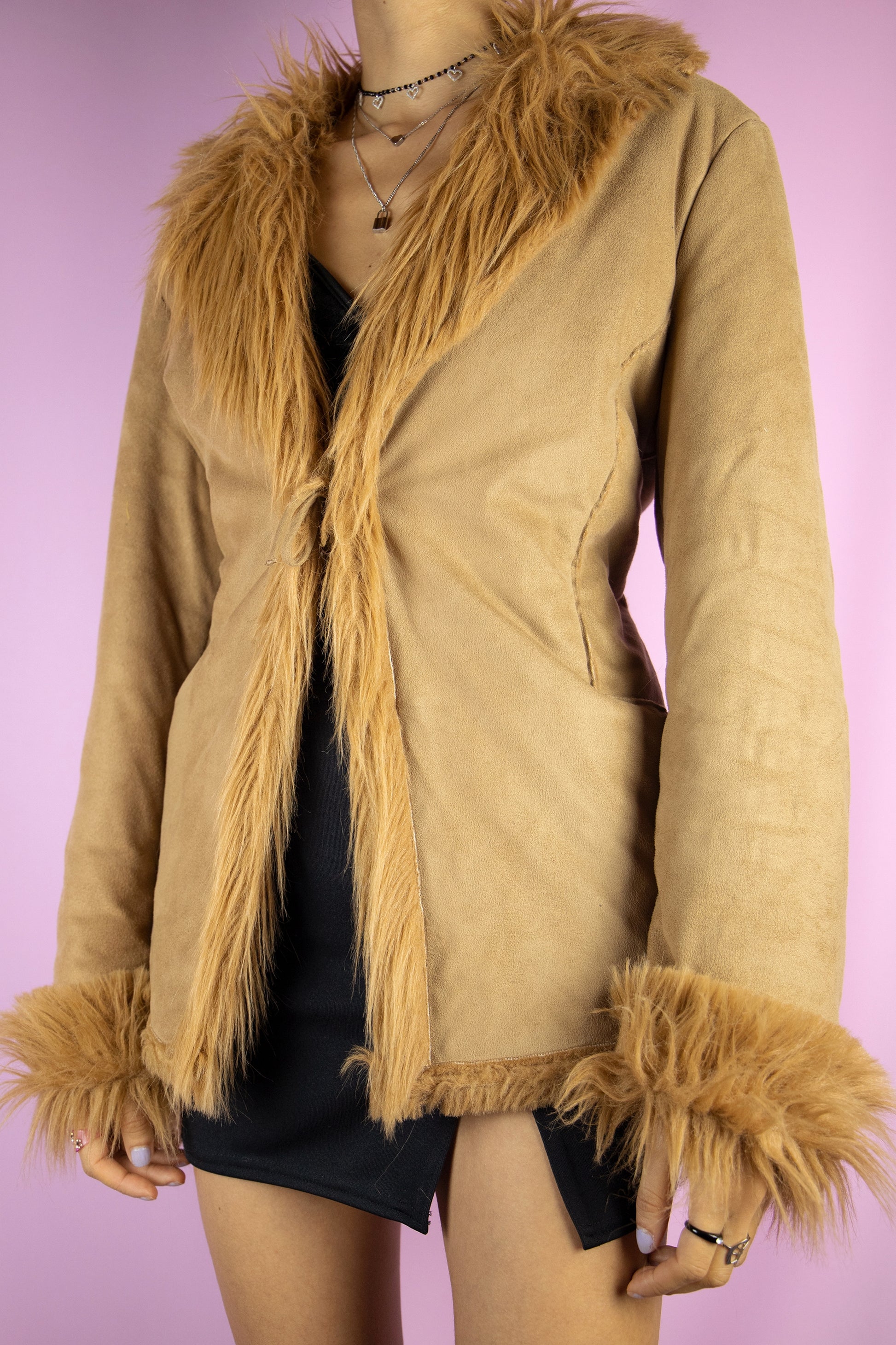 The Y2K Penny Lane Style Jacket is a vintage brown jacket with faux fur lining, collar and cuffs, it also has pockets and ties in the front. Iconic afghan style 2000s winter statement coat.