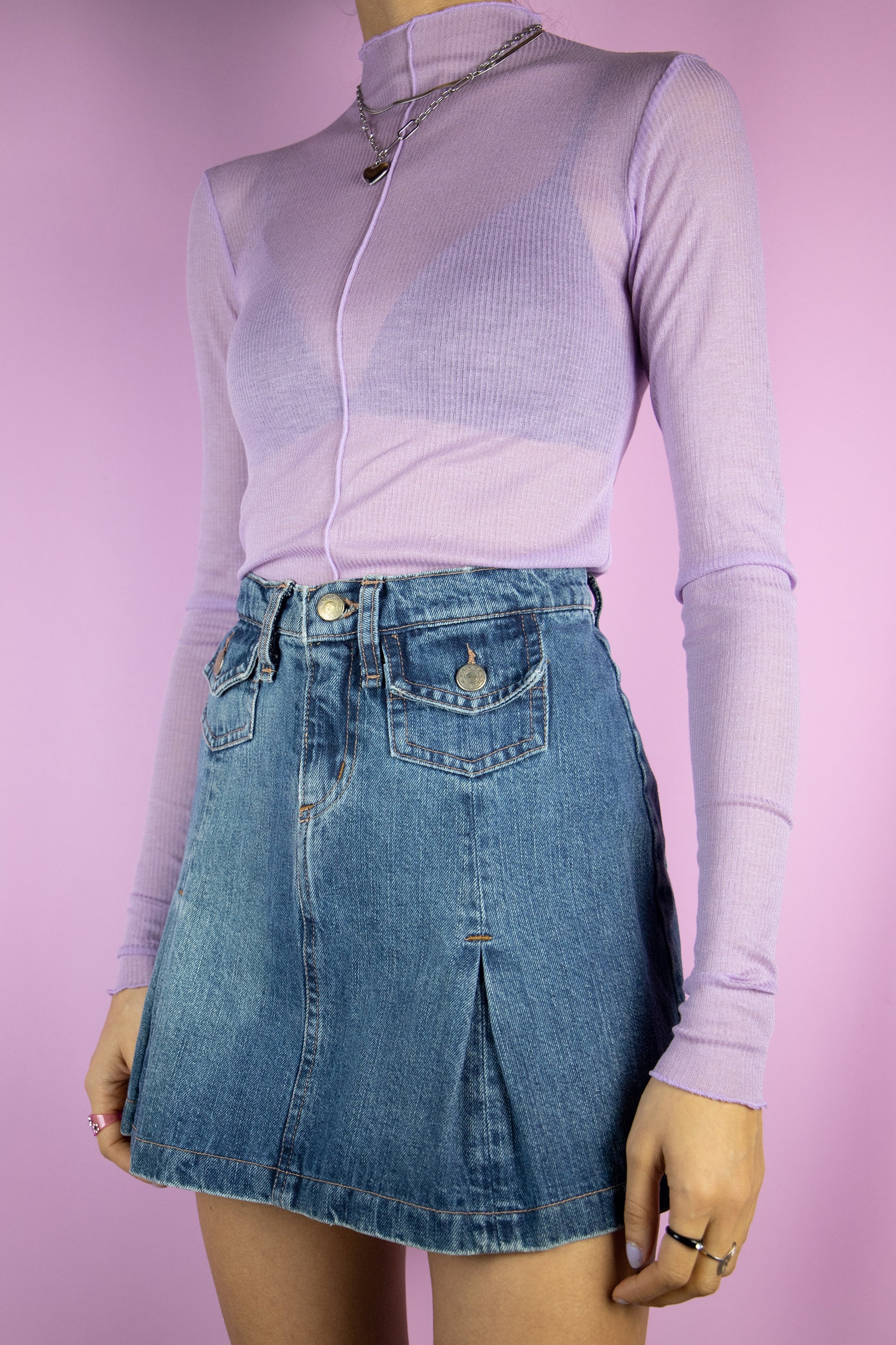 The Vintage 90s Denim Pleated Mini Skirt is a denim skirt with pleats and pockets. Cyber 2000s jean mini skirt.