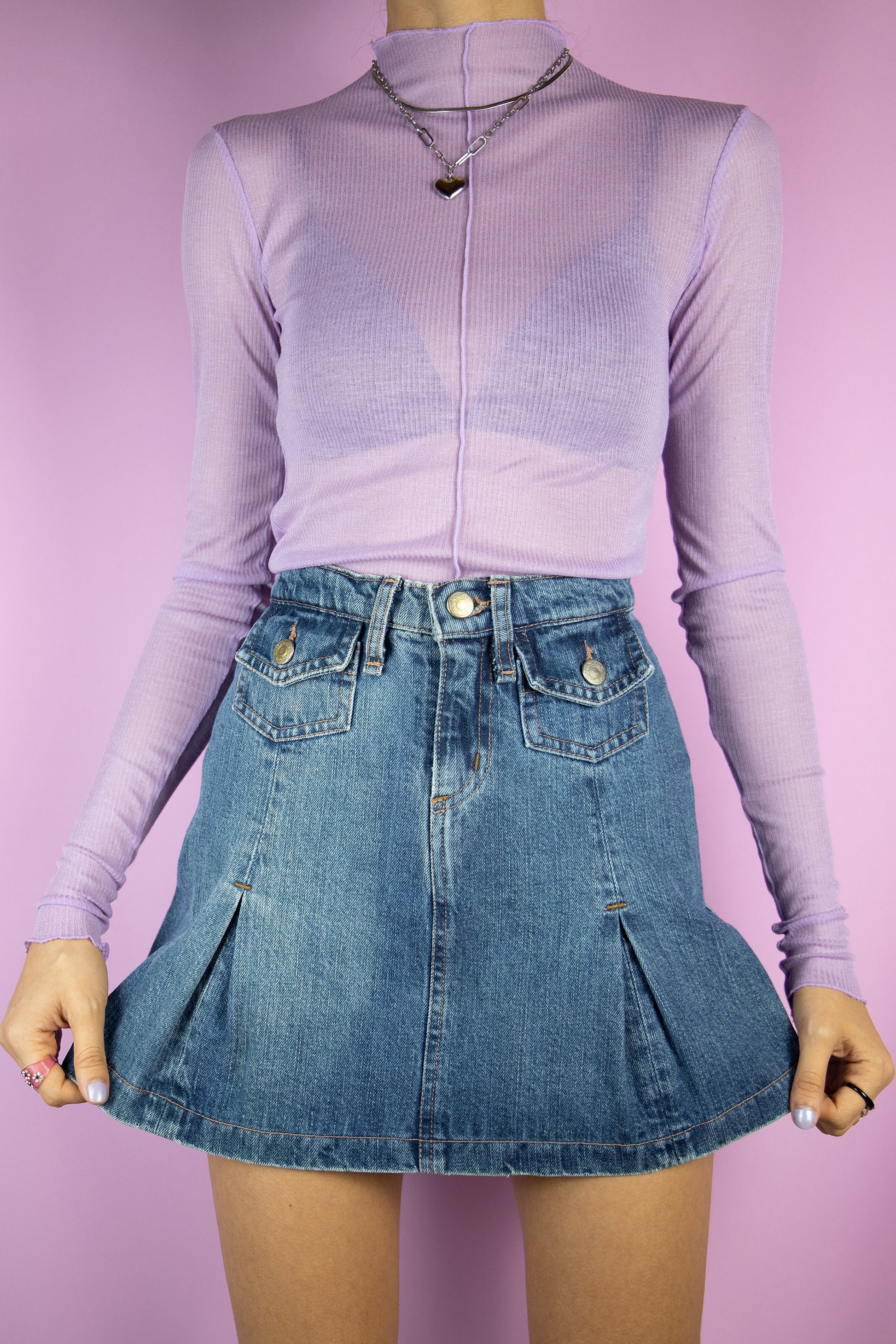The Vintage 90s Denim Pleated Mini Skirt is a denim skirt with pleats and pockets. Cyber 2000s jean mini skirt.