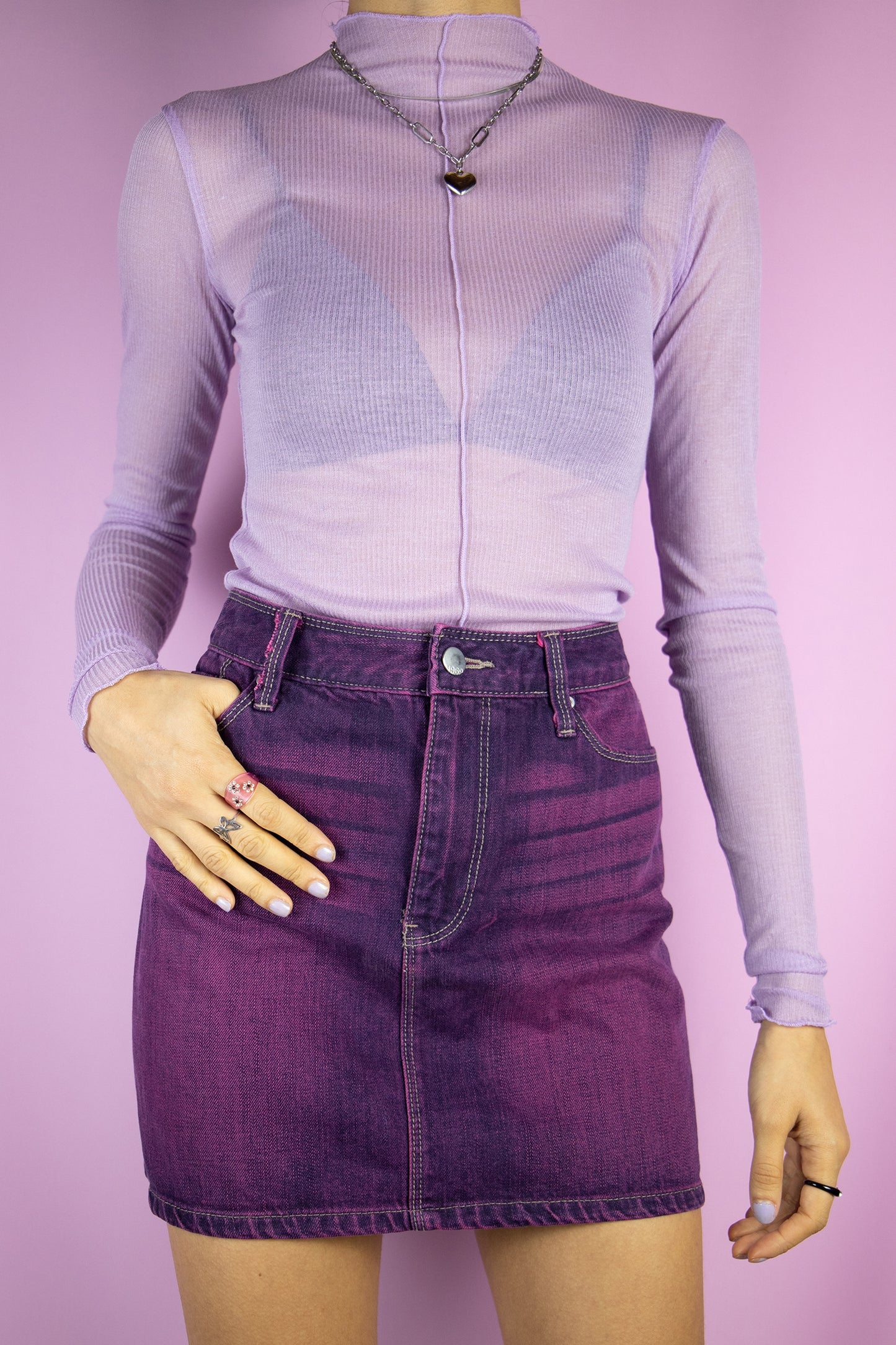 The Y2K Purple Denim Mini Skirt is a vintage dark purple acid wash denim skirt with pockets. Cyber grunge 2000s jean mini skirt.