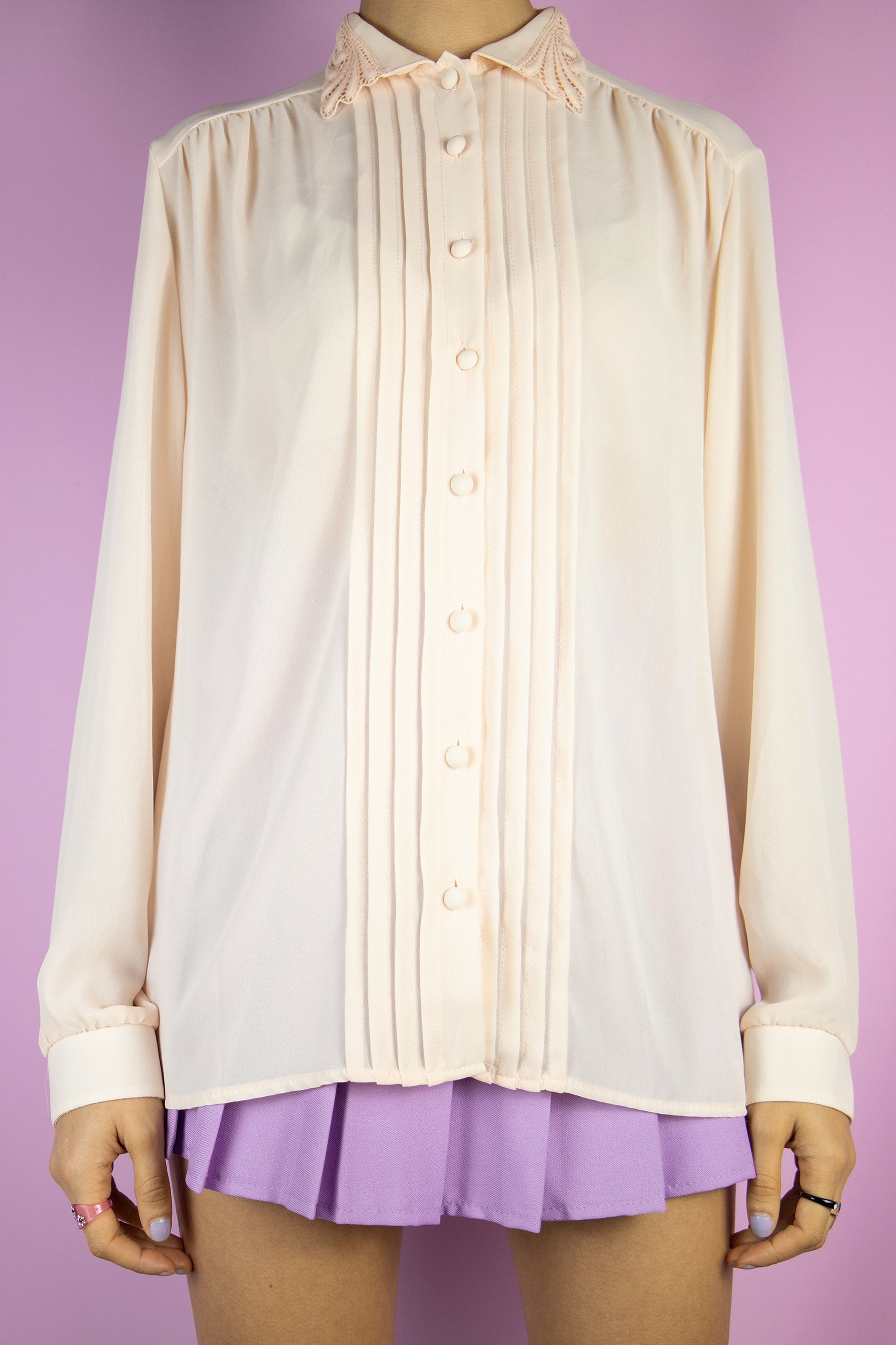 The Vintage 80s Light Pink Romantic Blouse is a semi sheer light pastel pink shirt with pleated front, collar and buttons. Preppy retro 1980s blouse.