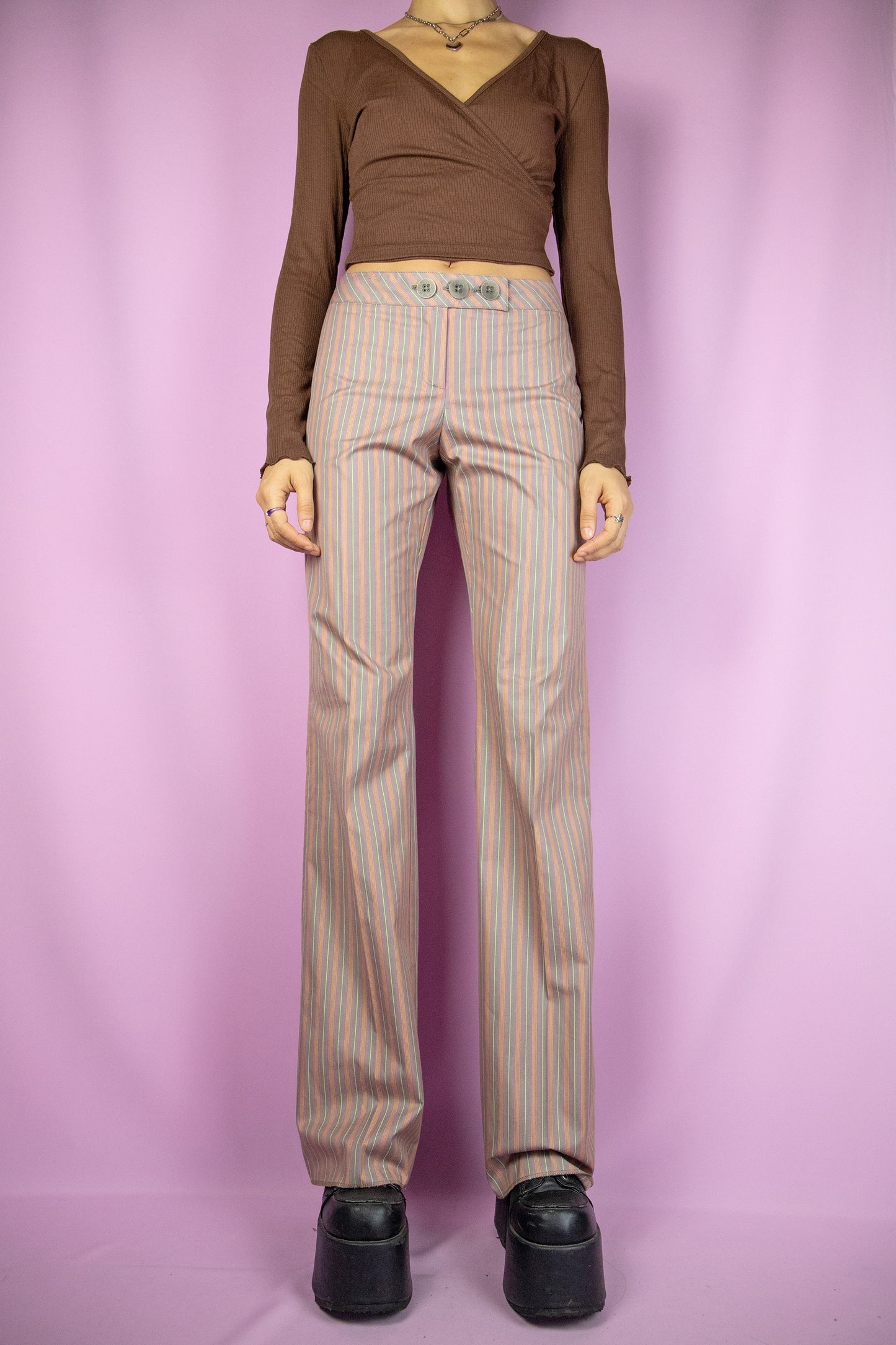 The Y2K Striped Wide Pants are vintage 2000s multicolored printed trousers with a zip and button closure.