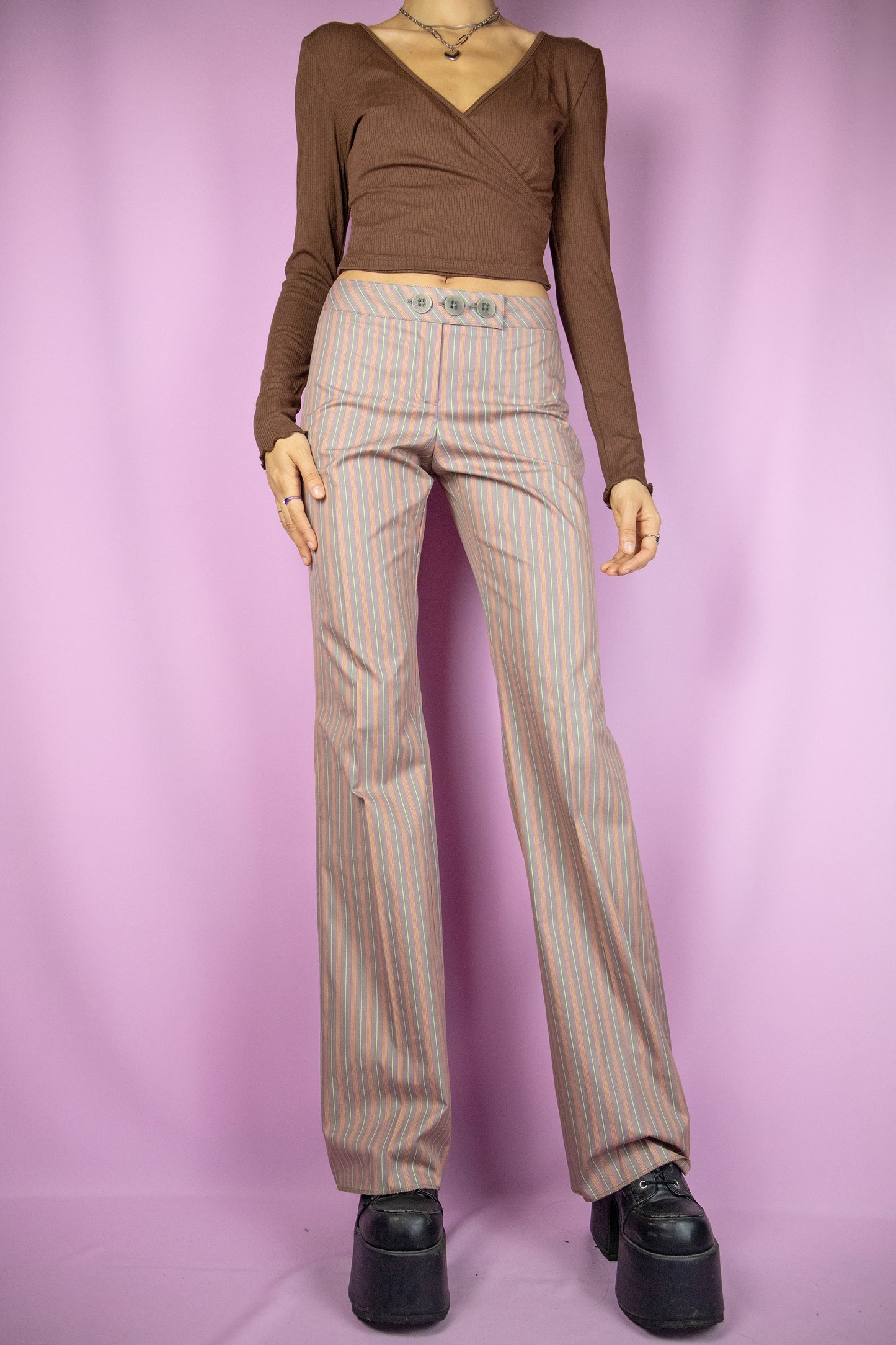 The Y2K Striped Wide Pants are vintage 2000s multicolored printed trousers with a zip and button closure.