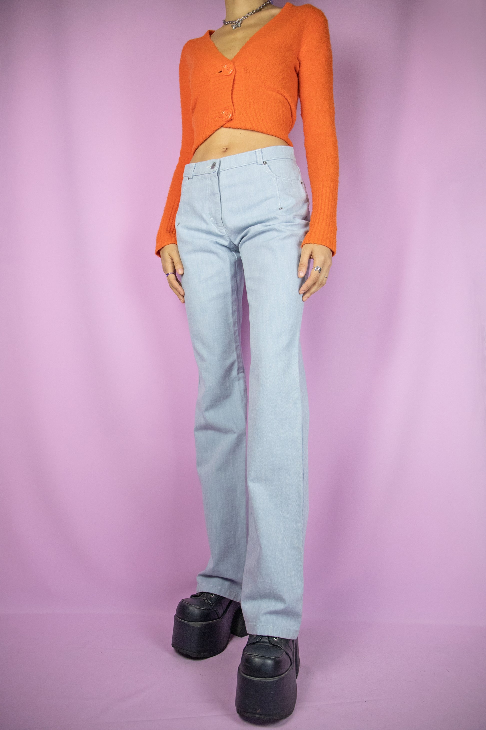 The Y2K Light Wash Bootcut Jeans are vintage light blue slightly flared mid-rise bootcut pants. Casual cyber 2000s denim trousers.