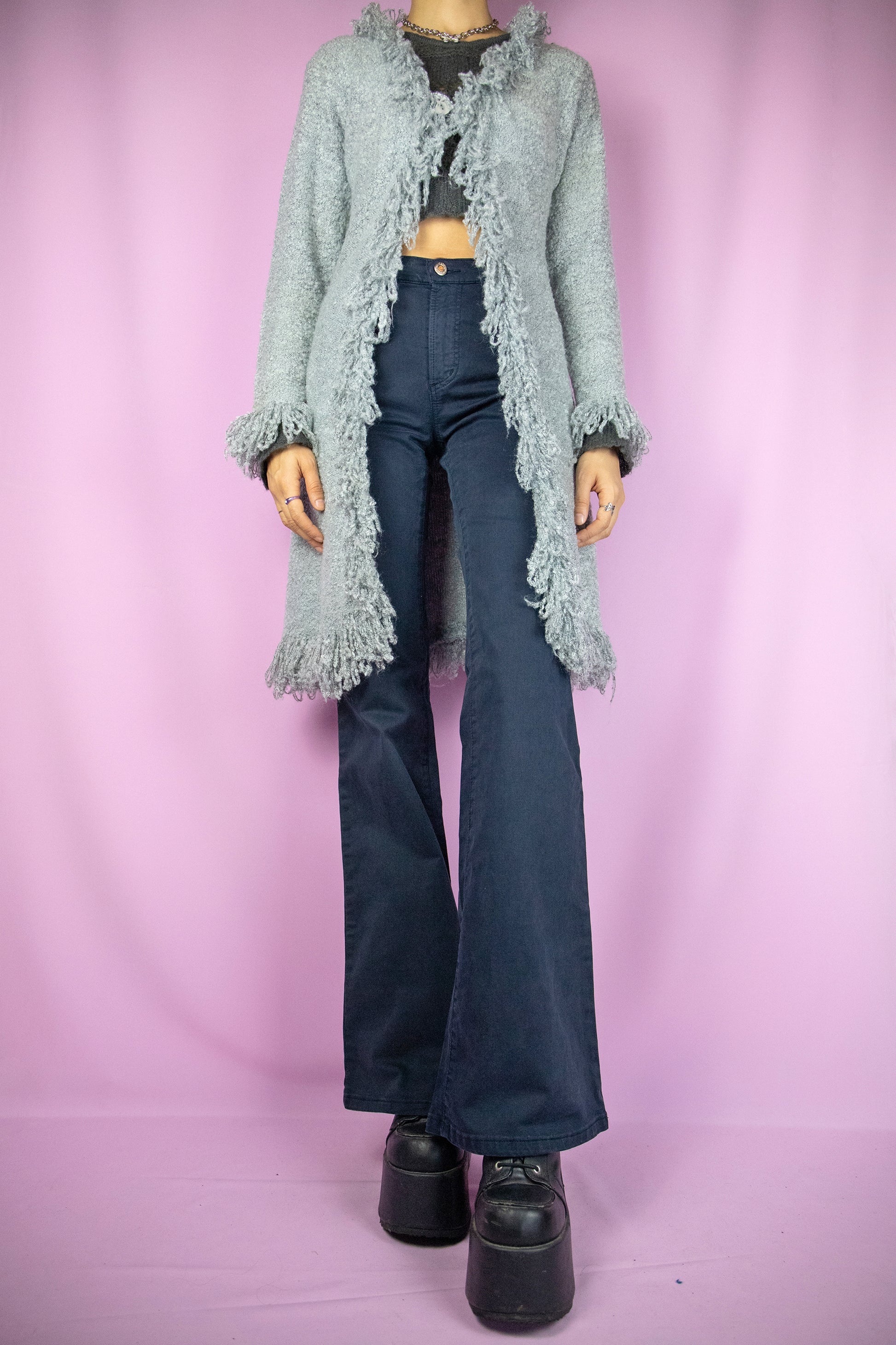 The Y2K Gray Penny Lane Cardigan is a vintage long shaggy knit cardigan with a one button closure and fringe trim at the neckline and cuffs. Cyber fairy grunge 2000s boho duster jacket.