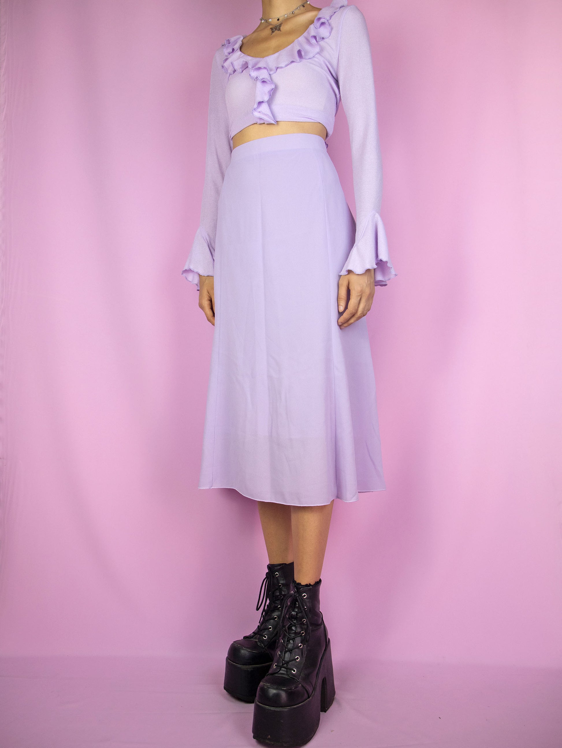 The Y2K Light Purple Midi Skirt is a vintage flared pastel light purple skirt with side zipper closure. Boho 2000s summer lilac midi skirt.