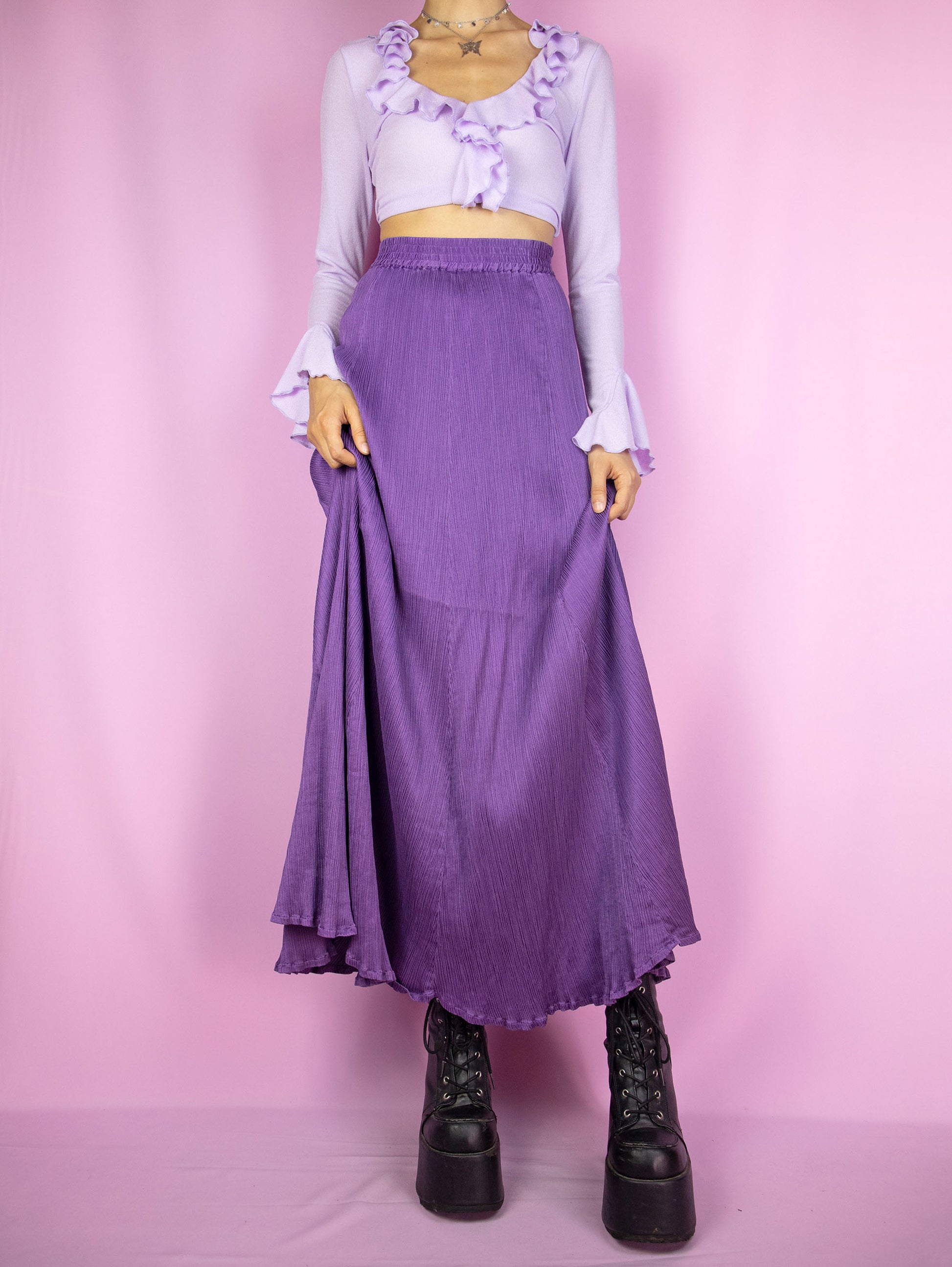 The Vintage 90s Purple Pleated Maxi Skirt is a flared pleated purple skirt with an elasticated waist. Gorgeous elegant boho 1990s midi skirt.